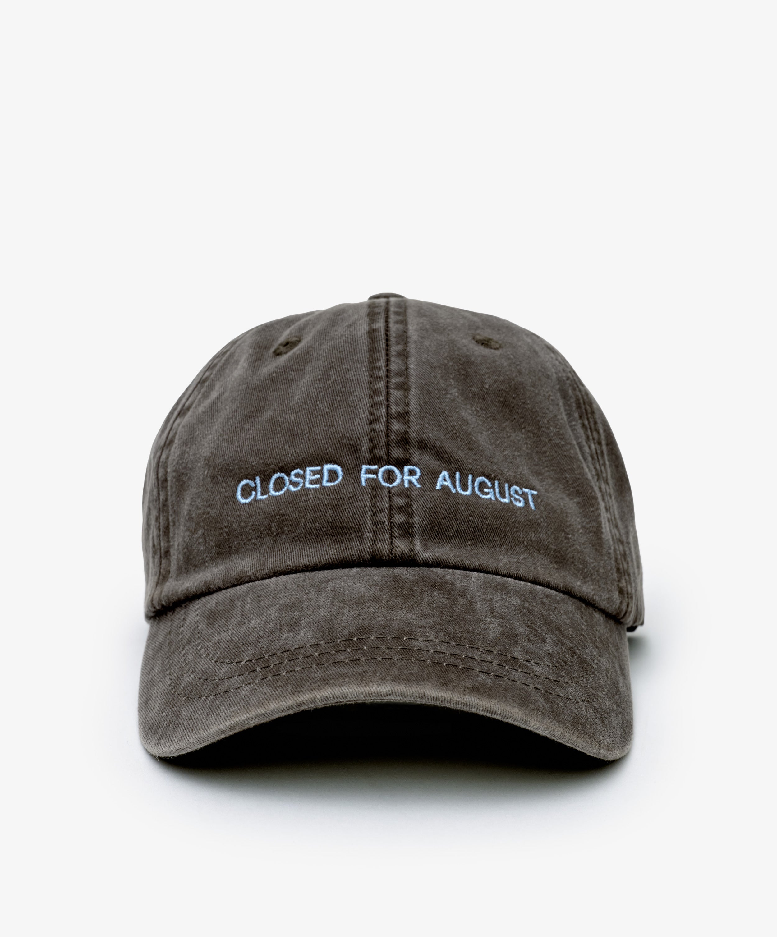 The Closed for August Cap is a brown baseball hat featuring light blue CLOSED FOR AUGUST embroidery on the front—perfect for channeling European summer vibes with easy style and sun protection.
