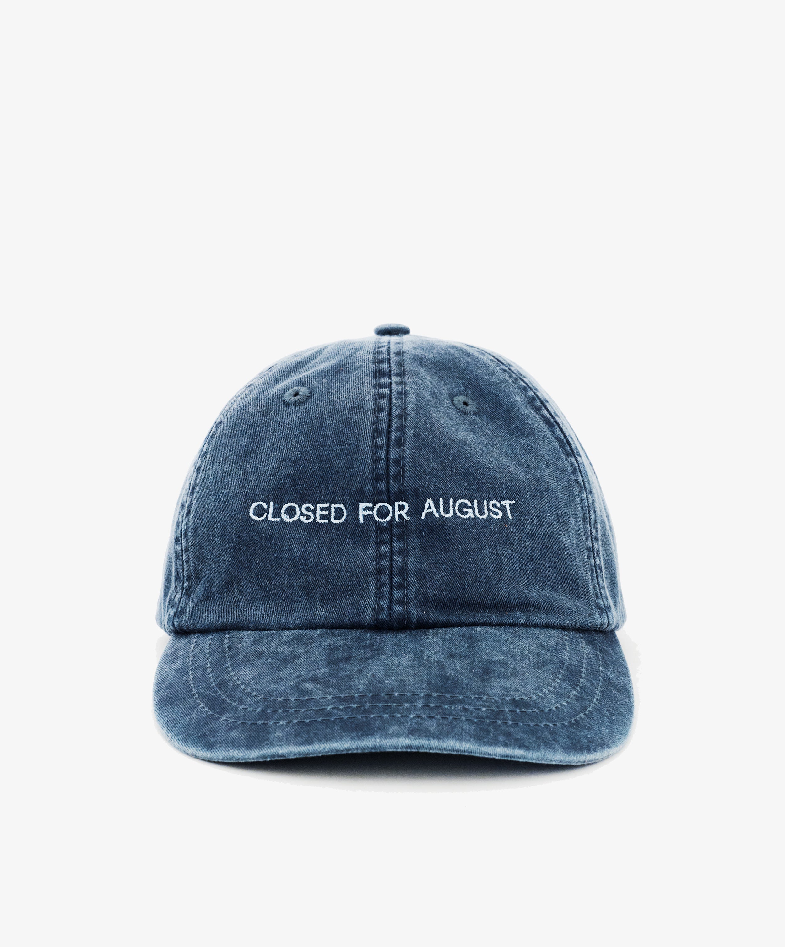 The Closed for August Cap is a blue denim baseball cap with white embroidered 