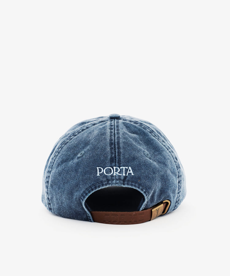 The Closed for August Cap is a blue denim hat with PORTA embroidered above an adjustable brown buckle strap at the back—ideal sun protection for your European getaways.