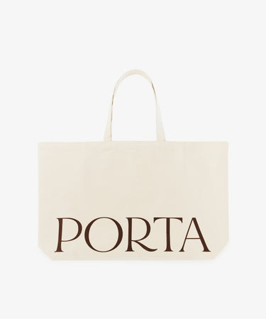 The PORTA Canvas Tote Bag is a spacious cream-colored tote with two handles and bold black 