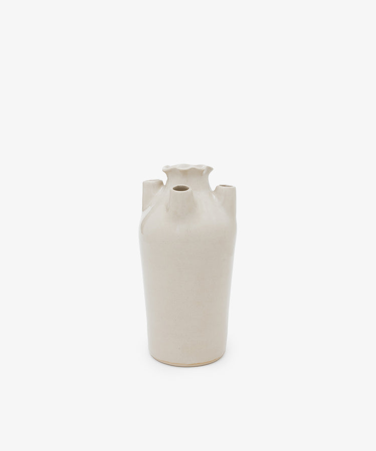 The Four Spouted Tulipere is a beige ceramic vase featuring a narrow base, fluted top, and four protruding spouts, echoing modern tulipiere design, displayed against a plain white background.