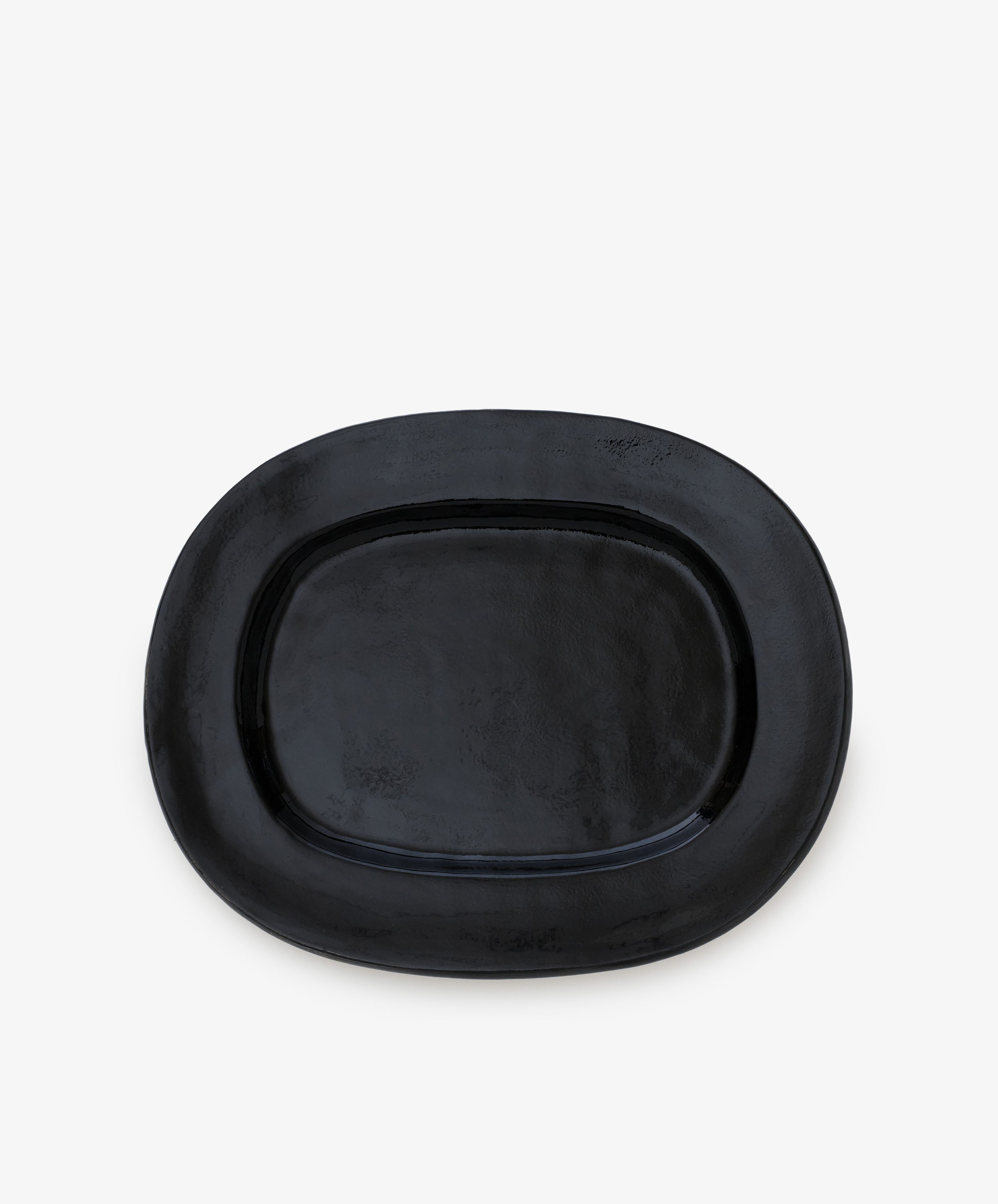 A large rectangular platter, crafted from ceramic and finished in black, is centered on a plain white background, showcasing the modern elegance of a contemporary serving piece.