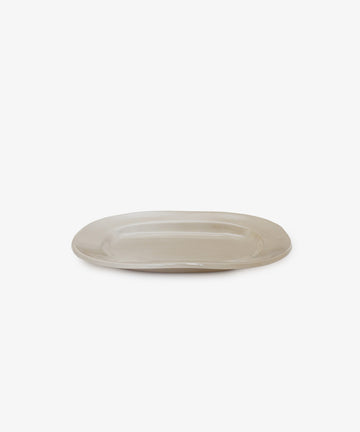The Small Rectangular Platter is an off-white ceramic piece with a matte surface, ideal for everyday use. Its plain, rectangular shape is shown against a white background.