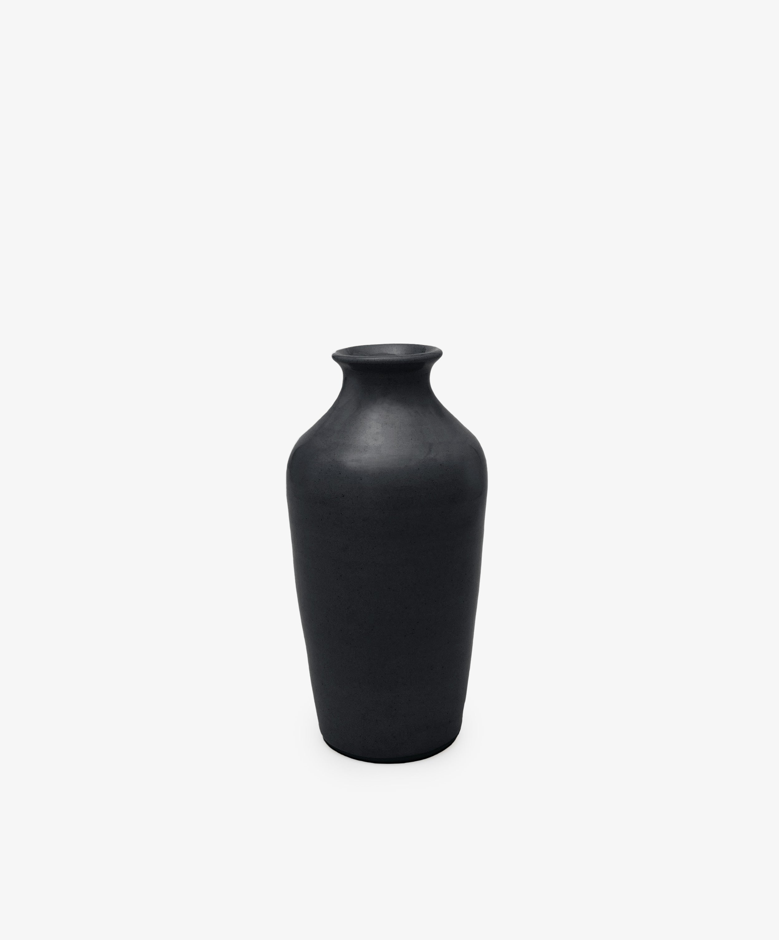 The Wheel Thrown Vase is a tall, matte black sculptural piece with a narrow neck and wide body, set against a plain white background.