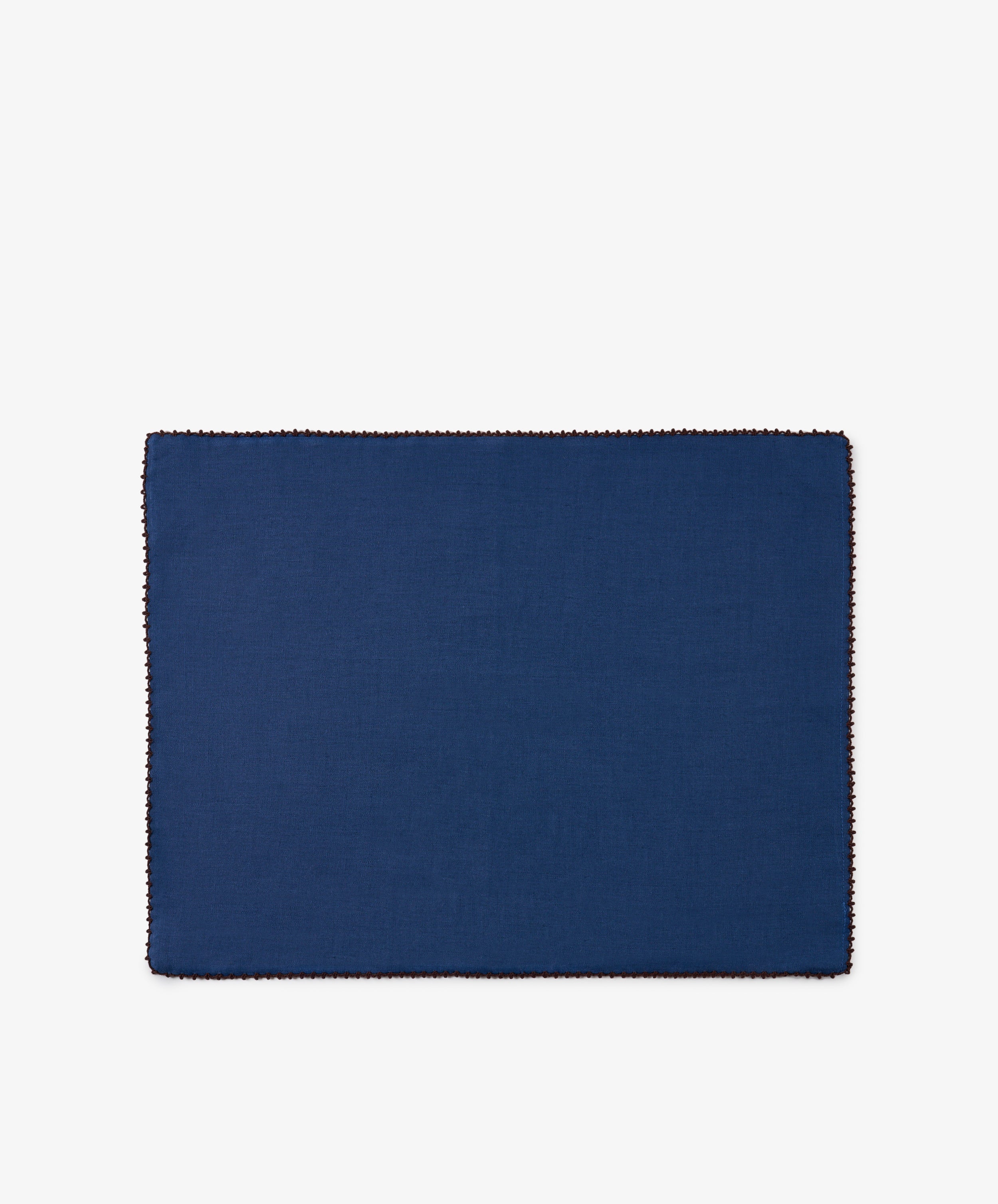 A set of six Nico Placemats, featuring a rectangular shape in indigo blue with stitched borders, is centered on a white background. These handmade placemats add a touch of elegance to any table setting.