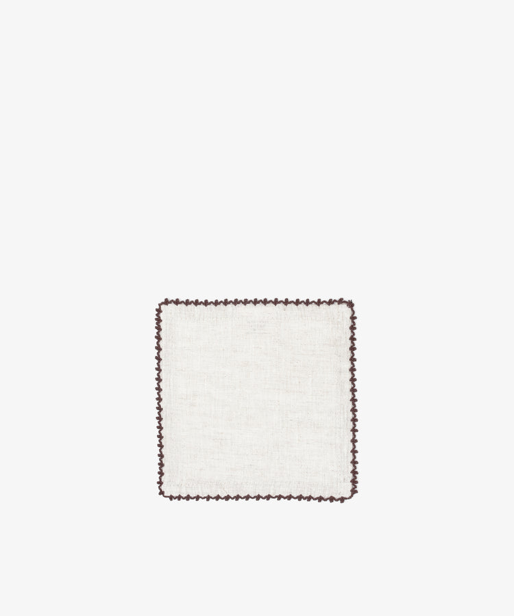 The Nico Cocktail Napkin, Set of 4, features hand-finished square white linen from Portugal with a dark scalloped border, set against a plain white background.