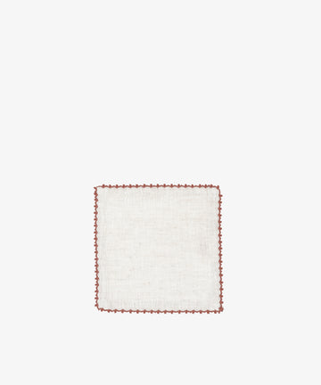 The Nico Cocktail Napkin, Set of 4, features square white cloth napkins with brown scalloped edging, hand-finished and crafted in Portugal—perfect for cocktail parties.