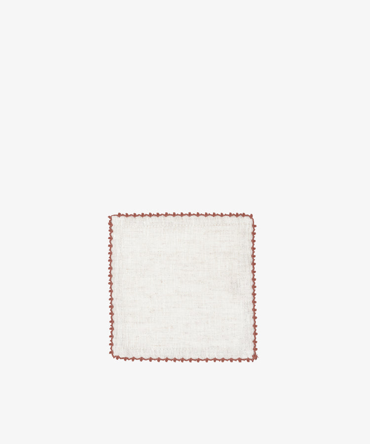 The Nico Cocktail Napkin, Set of 4, features square white cloth napkins with brown scalloped edging, hand-finished and crafted in Portugal—perfect for cocktail parties.