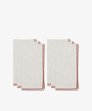 Two stacks of Nico Napkin, Set of 6, in light beige with red contrast edge stitching, are placed side by side on a white background.