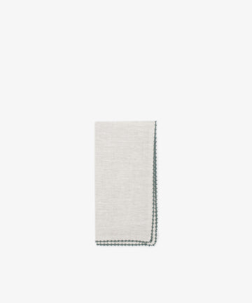 A set of 6 Nico Napkins in folded light gray linen with dark green stitched edges, displayed on a white background—an elegant, refined upgrade for your modern table linens collection.