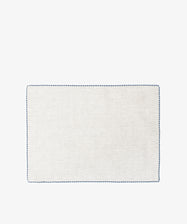 The Nico Placemat, Set of 6, features rectangular, light-colored linen with a simple blue hand-stitched edge—ideal for elegant table decor. Displayed on a white background.
