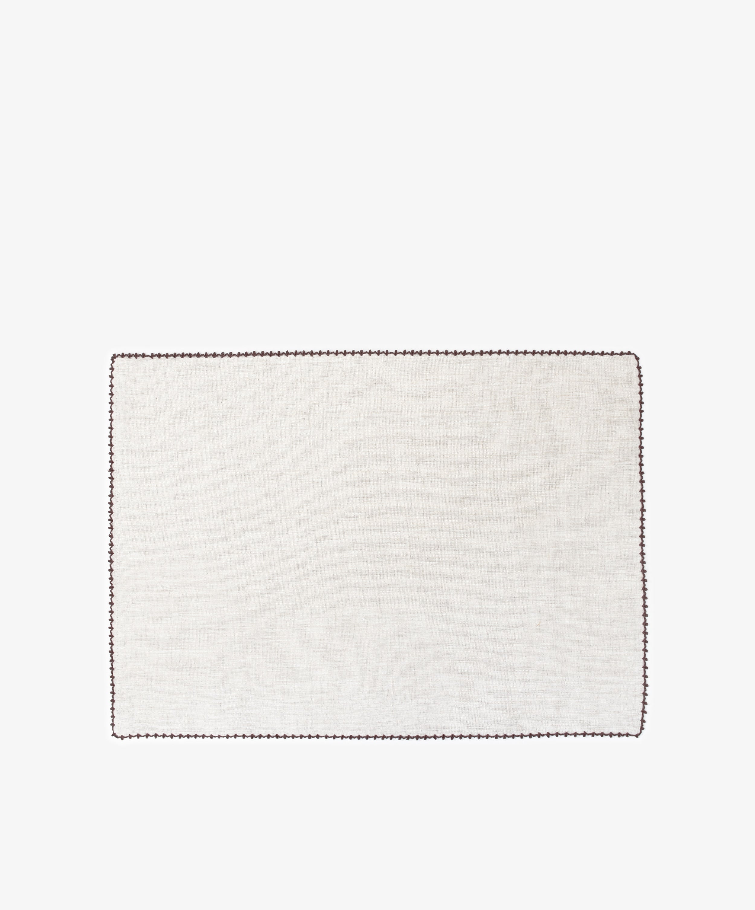The Nico Placemat, Set of 6, features rectangular light beige linen mats with hand-stitched edges and dark borders—ideal for adding elegance to your table.