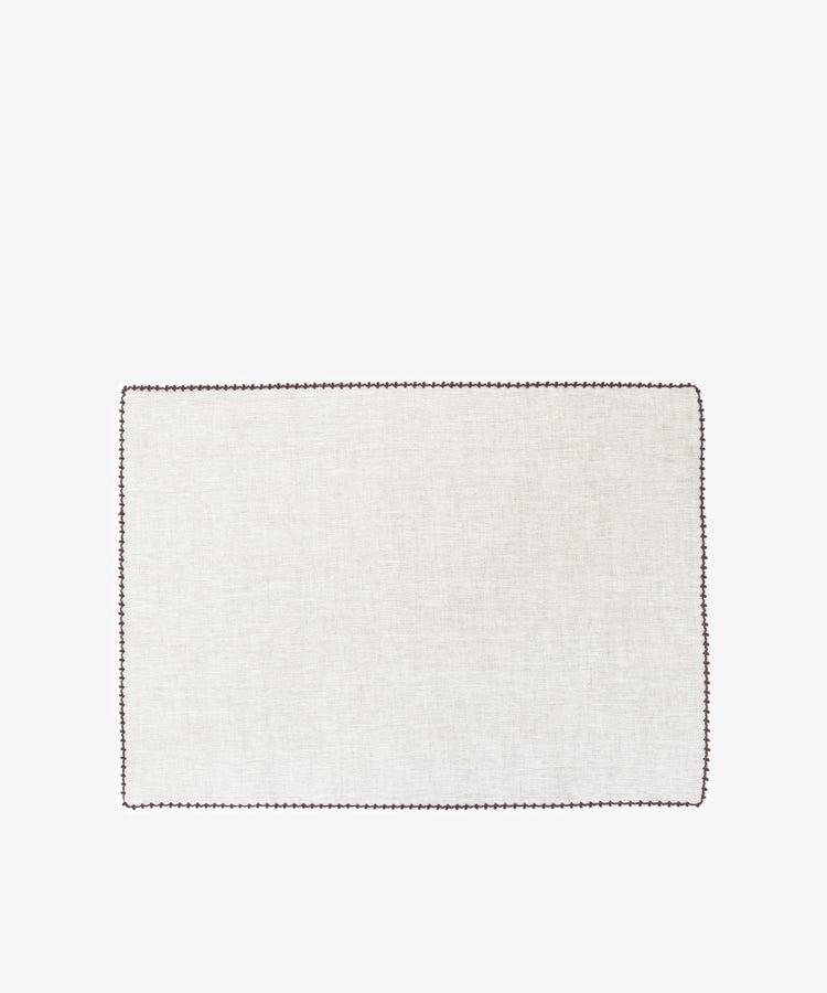 The Nico Placemat, Set of 6, features rectangular light beige linen mats with hand-stitched edges and dark borders—ideal for adding elegance to your table.
