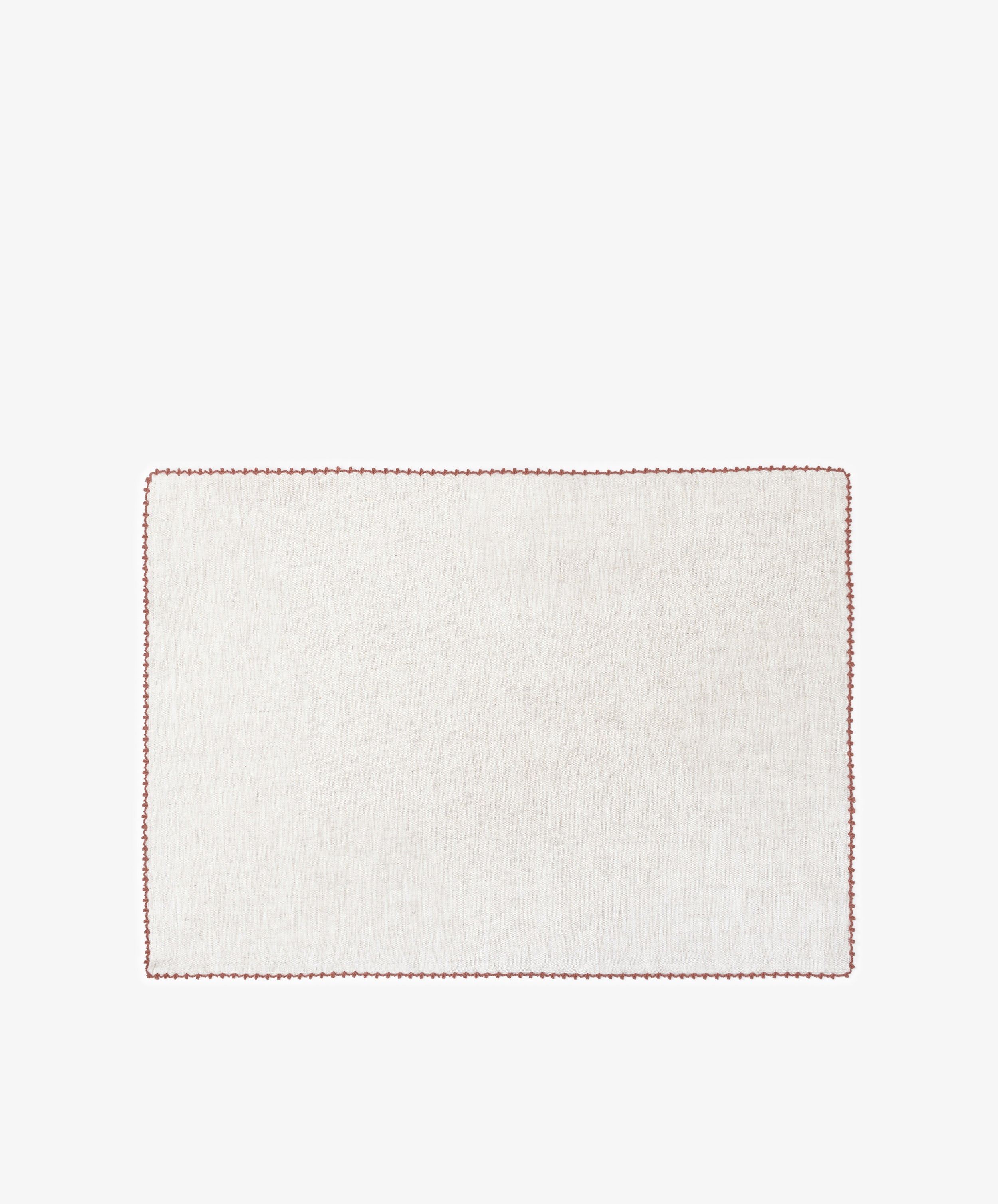 The Nico Placemat, Set of 6, features rectangular, light linen mats with elegant red hand-stitched edges—ideal for bringing refined style to any table setting.