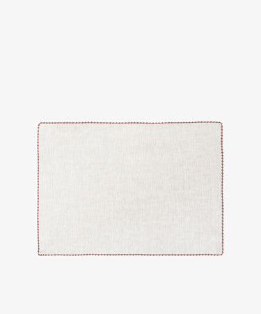 The Nico Placemat, Set of 6, features rectangular, light linen mats with elegant red hand-stitched edges—ideal for bringing refined style to any table setting.