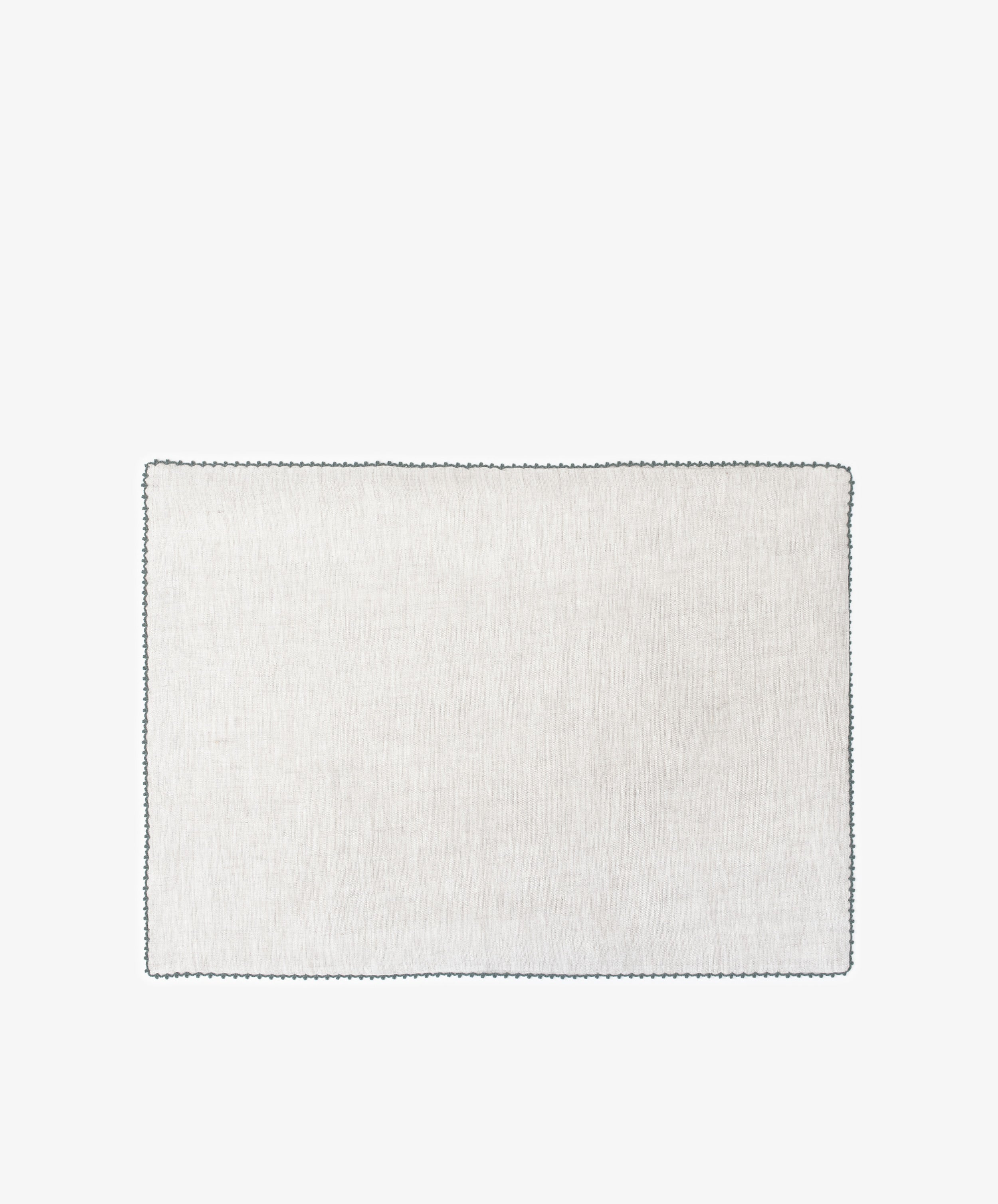 The Nico Placemat, Set of 6, features white squares with black borders and hand-stitched edges—ideal for elegant table decor or refined linen placemats.