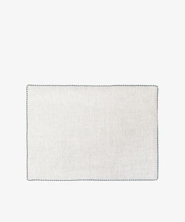 The Nico Placemat, Set of 6, features white squares with black borders and hand-stitched edges—ideal for elegant table decor or refined linen placemats.