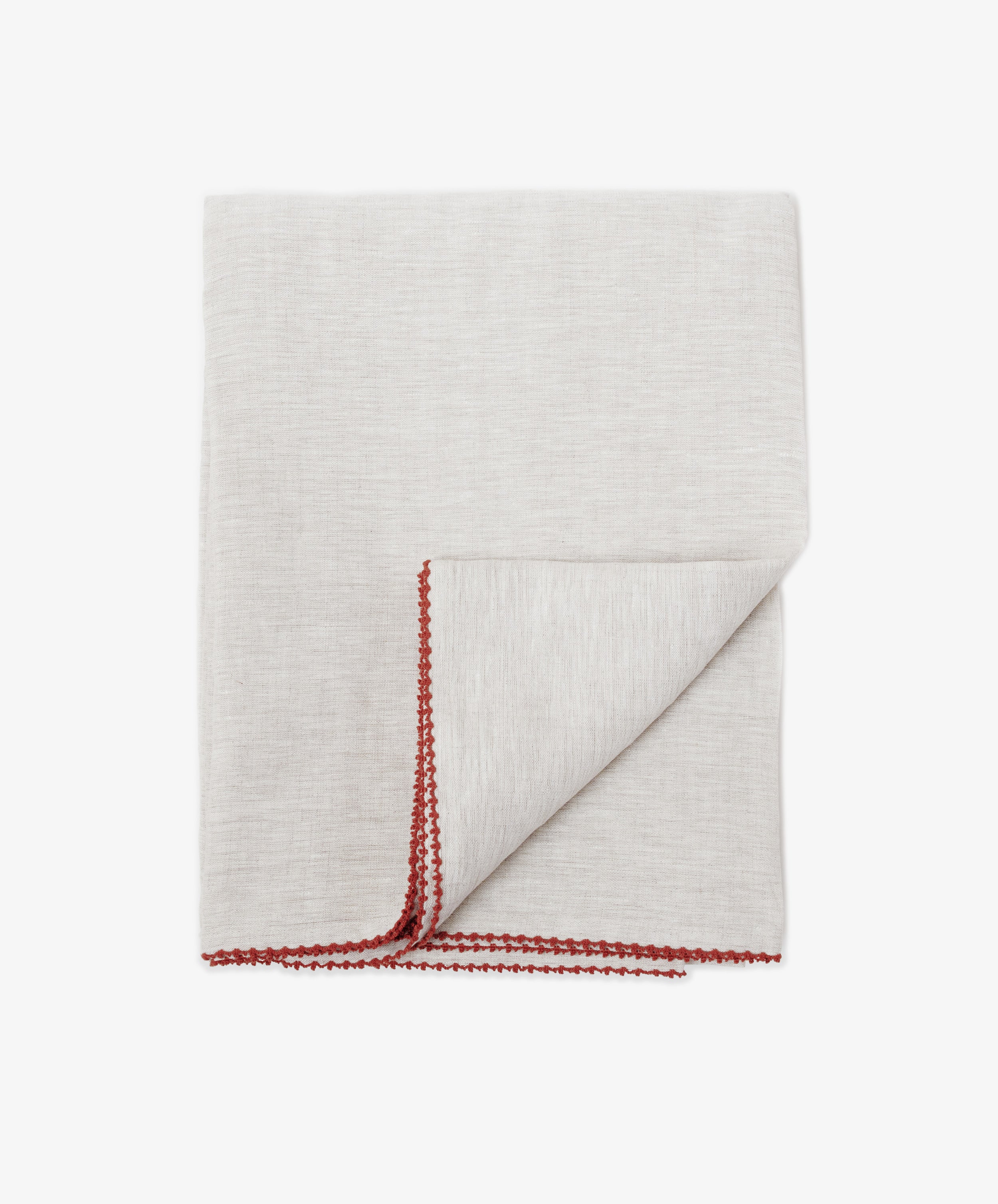 The Nico Tablecloth in light gray features a red hand-stitched border along the edges—an elegant detail that adds sophistication to your table setting.