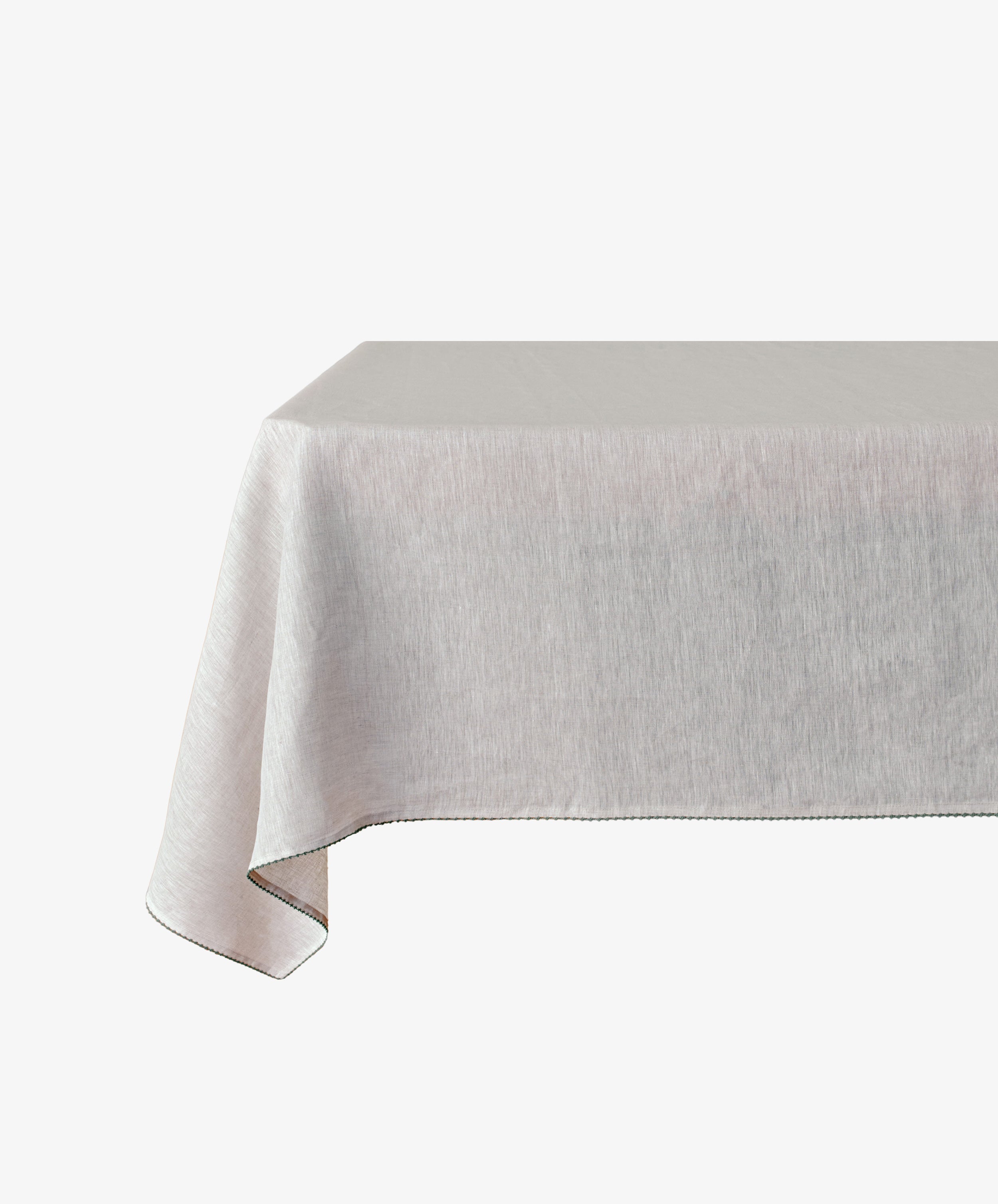 A rectangular table draped with the Nico Tablecloth, a light gray linen featuring subtle hand-stitched detail, set against a white background.
