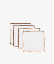 Set of 4 Nico Cocktail Napkins in white, each with brown contrast stitching on the edges, hand-finished and displayed in a staggered row on a white background.