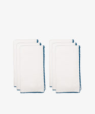 The Nico Napkin, Set of 6, features neatly folded white cloth napkins with blue stitched bordersâ€”ideal for adding a refined touch to your dinner parties.