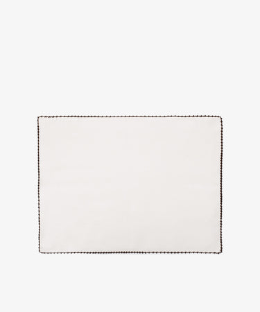 The Nico Placemat, Set of 6, features rectangular white linen with a dark hand-stitched edge, displayed on a plain white backgroundâ€”ideal for bringing Italian elegance to your table.