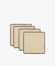 A set of four Nico Cocktail Napkins in beige, each hand-finished with dark brown scalloped edges for a refined touch, are neatly arranged in a staggered stack on a plain white background.
