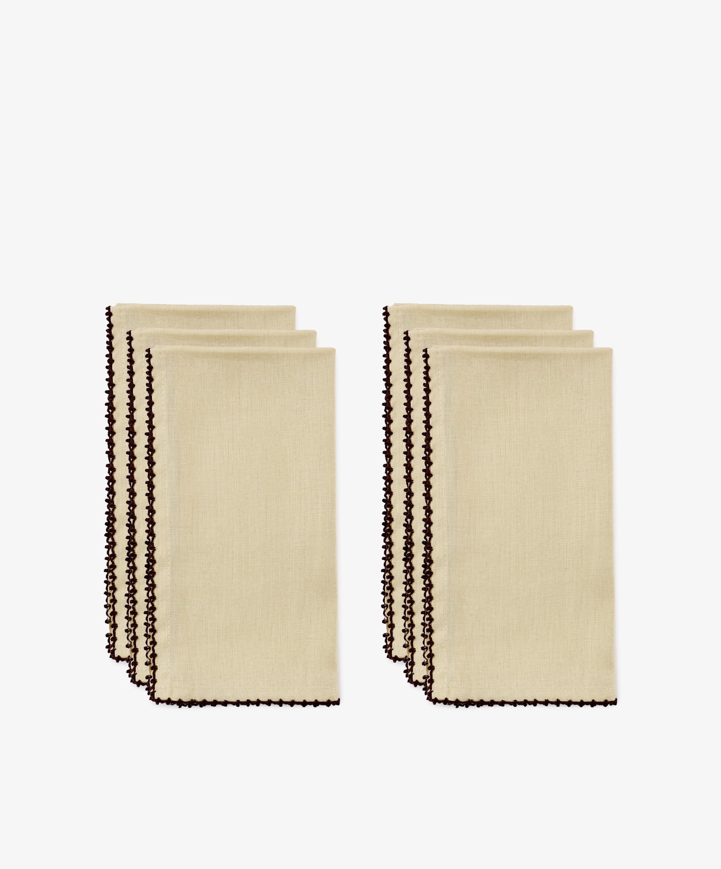 Four folded beige hand-finished napkins with dark espresso contrast stitch along the edges, arranged in two groups of two, on a white background.