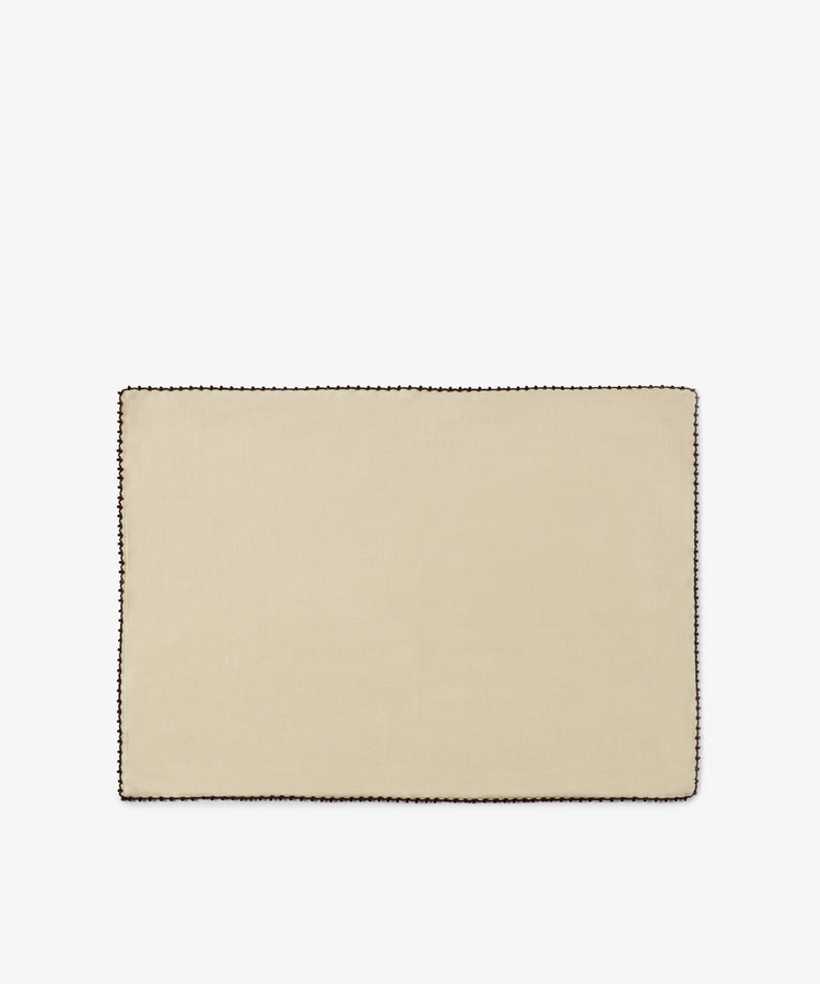 The Nico Placemat, Set of 6 features a rectangular design in beige linen with an espresso stitch border in a contrasting dark color, hand finished for a refined touch, and displayed on a plain white background.