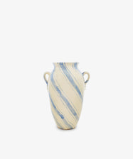 Amended Description: The Ida Vase is a tall ceramic piece with two side handles, inspired by an amphora-shaped silhouette. It features a cream base adorned with hand-painted blue lines in a light diagonal stripe pattern, all presented against a plain white background.