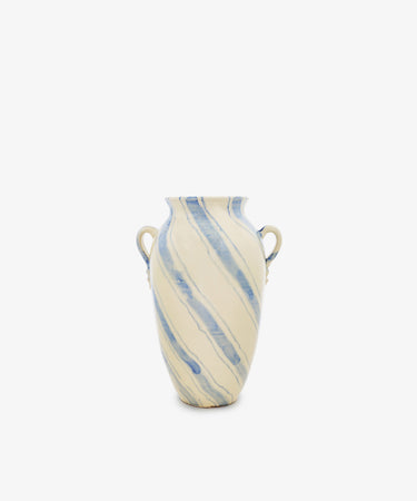 Amended Description: The Ida Vase is a tall ceramic piece with two side handles, inspired by an amphora-shaped silhouette. It features a cream base adorned with hand-painted blue lines in a light diagonal stripe pattern, all presented against a plain white background.