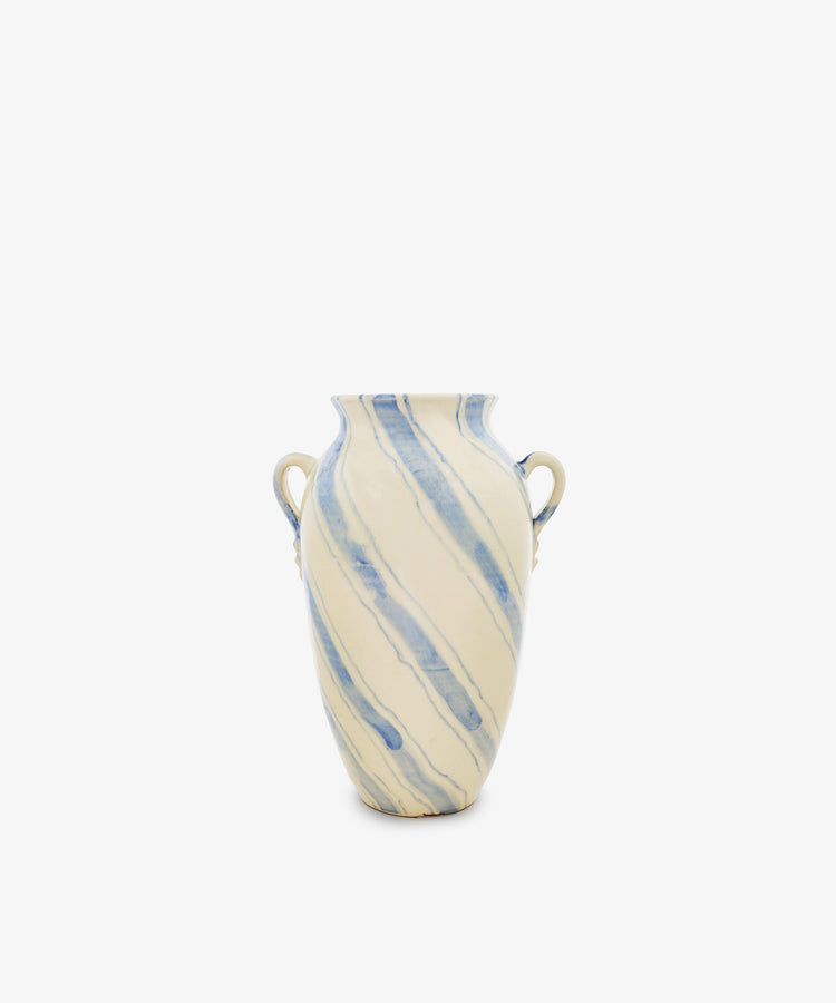 Amended Description: The Ida Vase is a tall ceramic piece with two side handles, inspired by an amphora-shaped silhouette. It features a cream base adorned with hand-painted blue lines in a light diagonal stripe pattern, all presented against a plain white background.