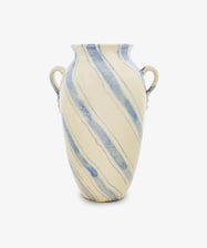 The Ida Vase, an amphora-shaped ceramic piece in cream with two handles and bold blue diagonal streaks, stands out against a plain white background—perfect for adding modern elegance to your home decor.