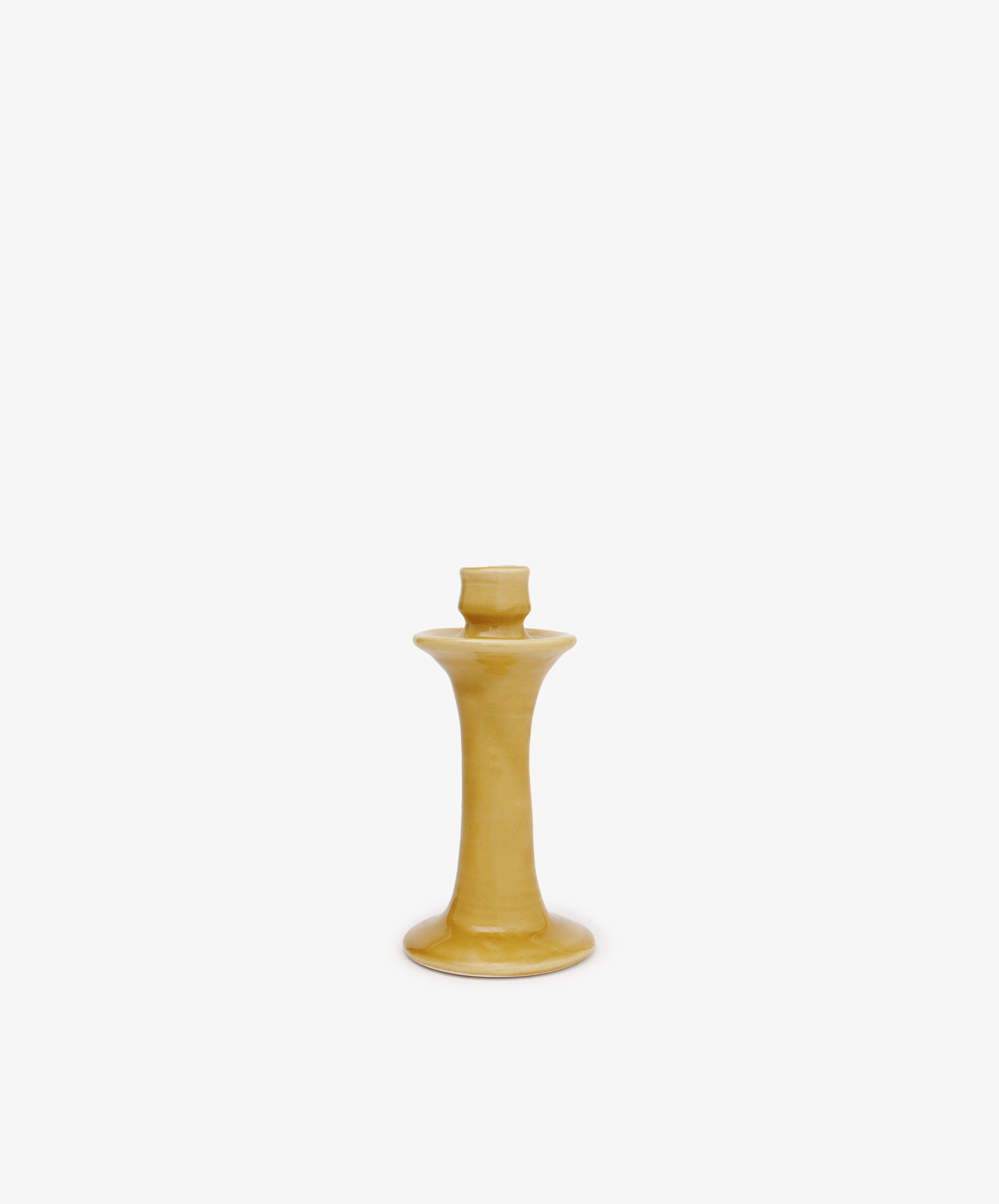 The Angelita Candleholder, a handcrafted yellow ceramic piece with a wide base and narrow neck, is displayed on a plain white background—ideal for adding Spanish charm to any space.