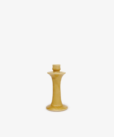 The Angelita Candleholder, a handcrafted yellow ceramic piece with a wide base and narrow neck, is displayed on a plain white background—ideal for adding Spanish charm to any space.