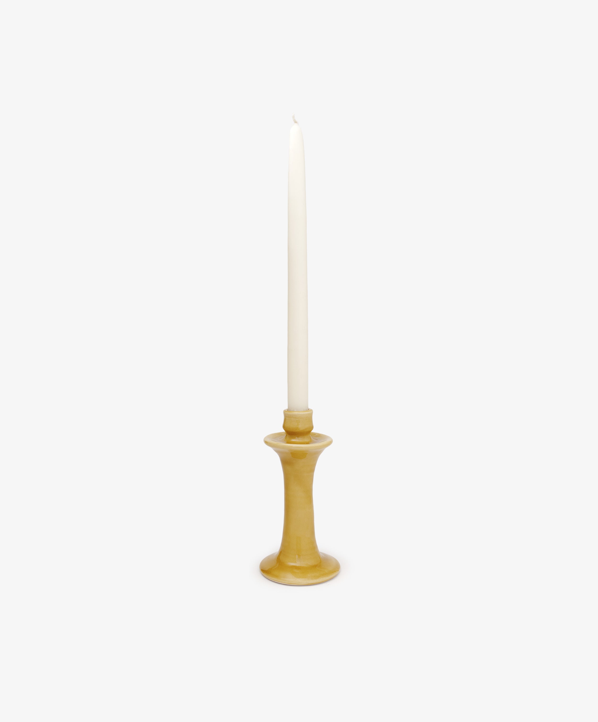 The Angelita Candleholder, a handcrafted ceramic piece, holds a single white taper candle upright, bringing a touch of Spanish decor to any space against a plain white background.