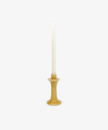 The Angelita Candleholder, a handcrafted ceramic piece, holds a single white taper candle upright, bringing a touch of Spanish decor to any space against a plain white background.