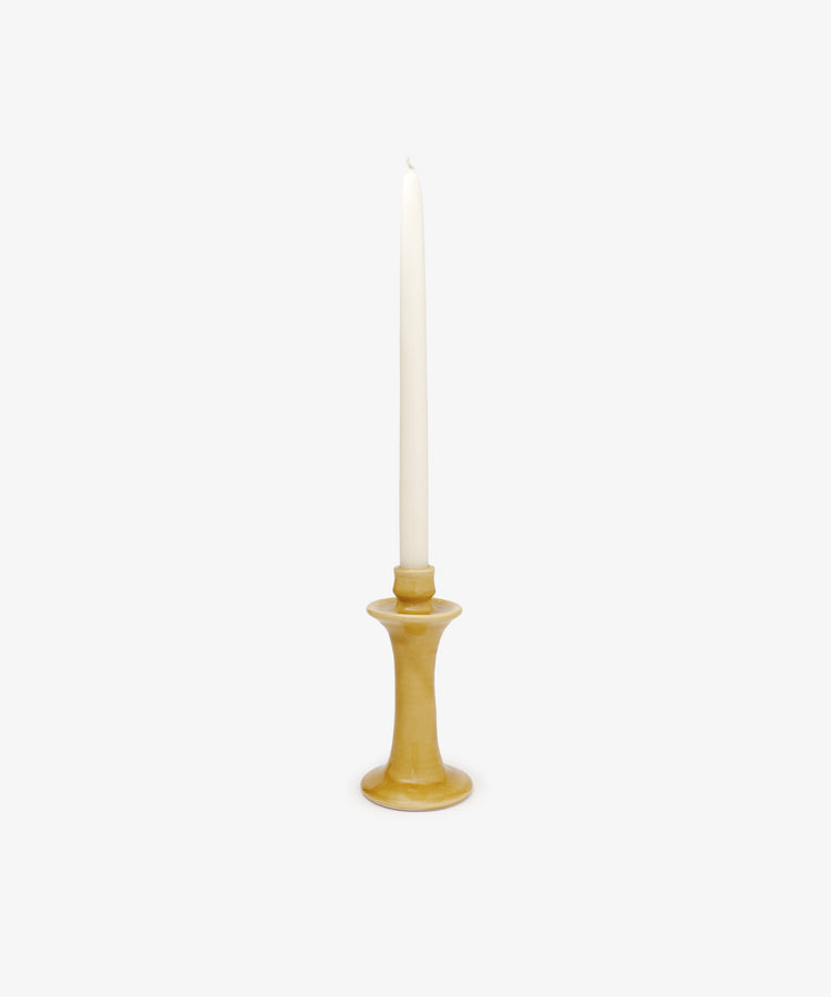 The Angelita Candleholder, a handcrafted ceramic piece, holds a single white taper candle upright, bringing a touch of Spanish decor to any space against a plain white background.