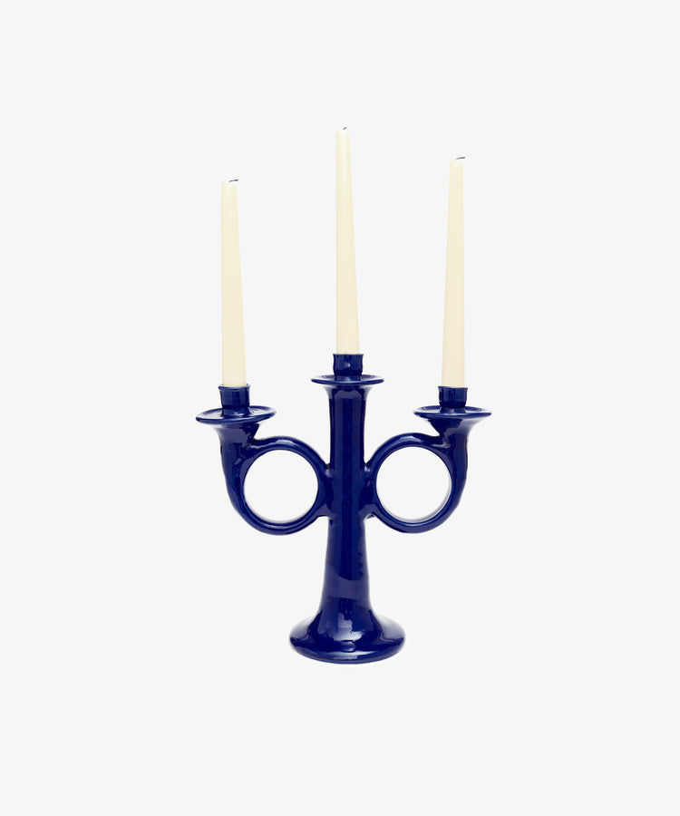 Loretta Candelabra. Dark blue glazed ceramic candle holder with three white taper candles.