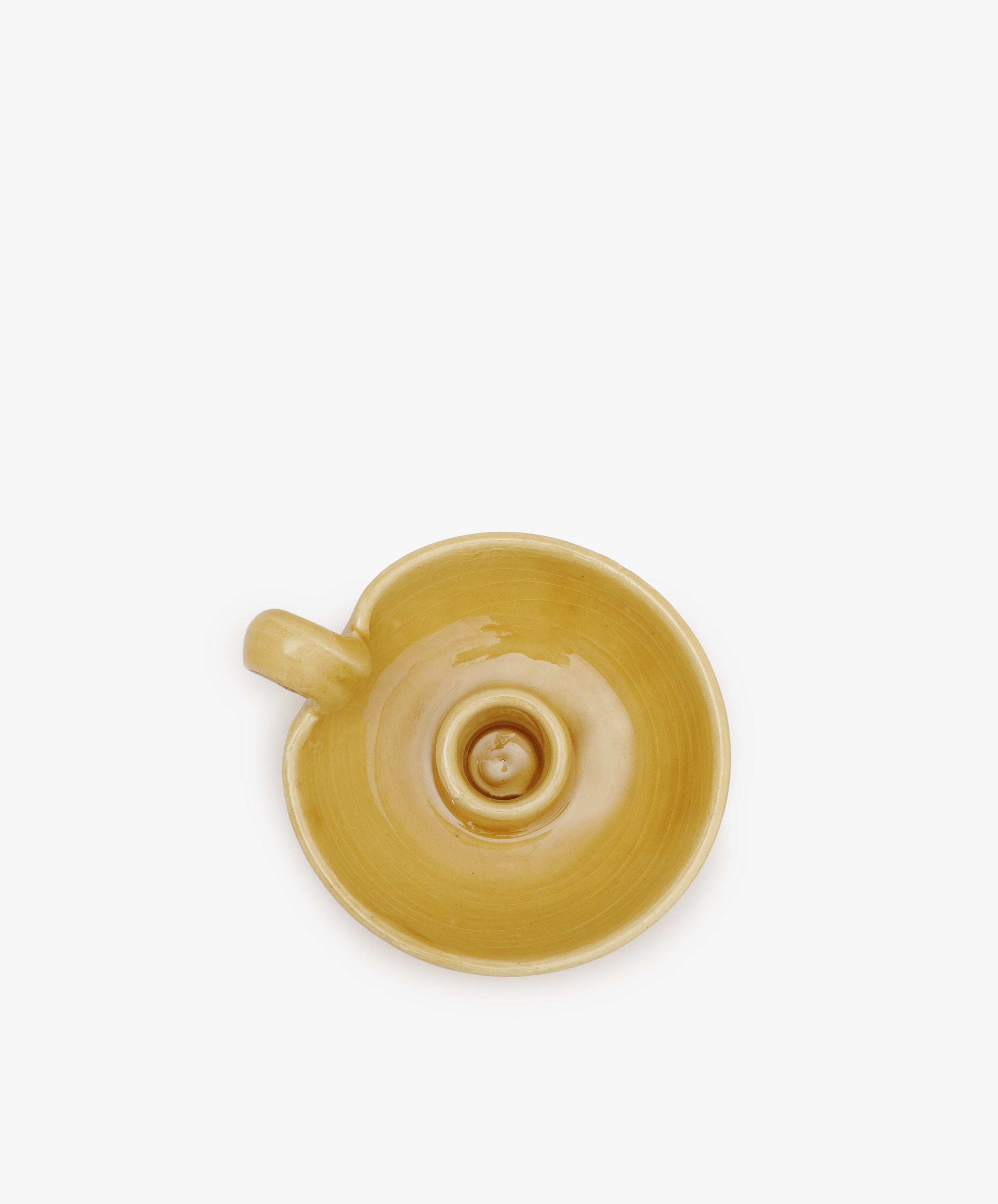 The Balea Candleholder seen from above features a yellow ceramic finish and a unique spiral design in the center, evoking handmade Old World charm.