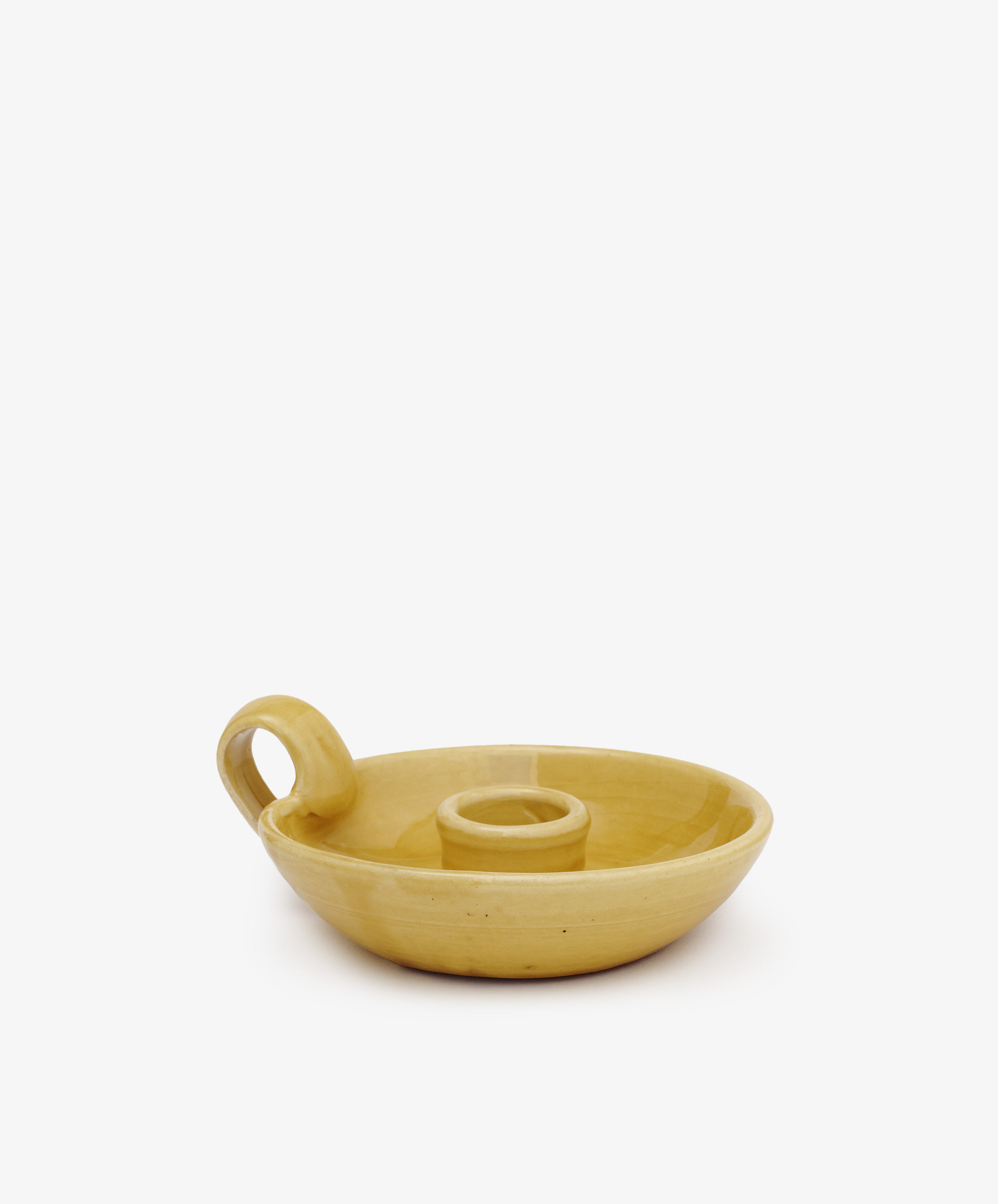 The Balea Candleholder is a yellow ceramic chamberstick with Old World charm, featuring a round base, central candle holder, and side loop handle, shown on a plain white background.