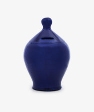 The Hugo Money Pot is a blue ceramic bank featuring a rounded body, narrow neck, and a coin slot near the top.