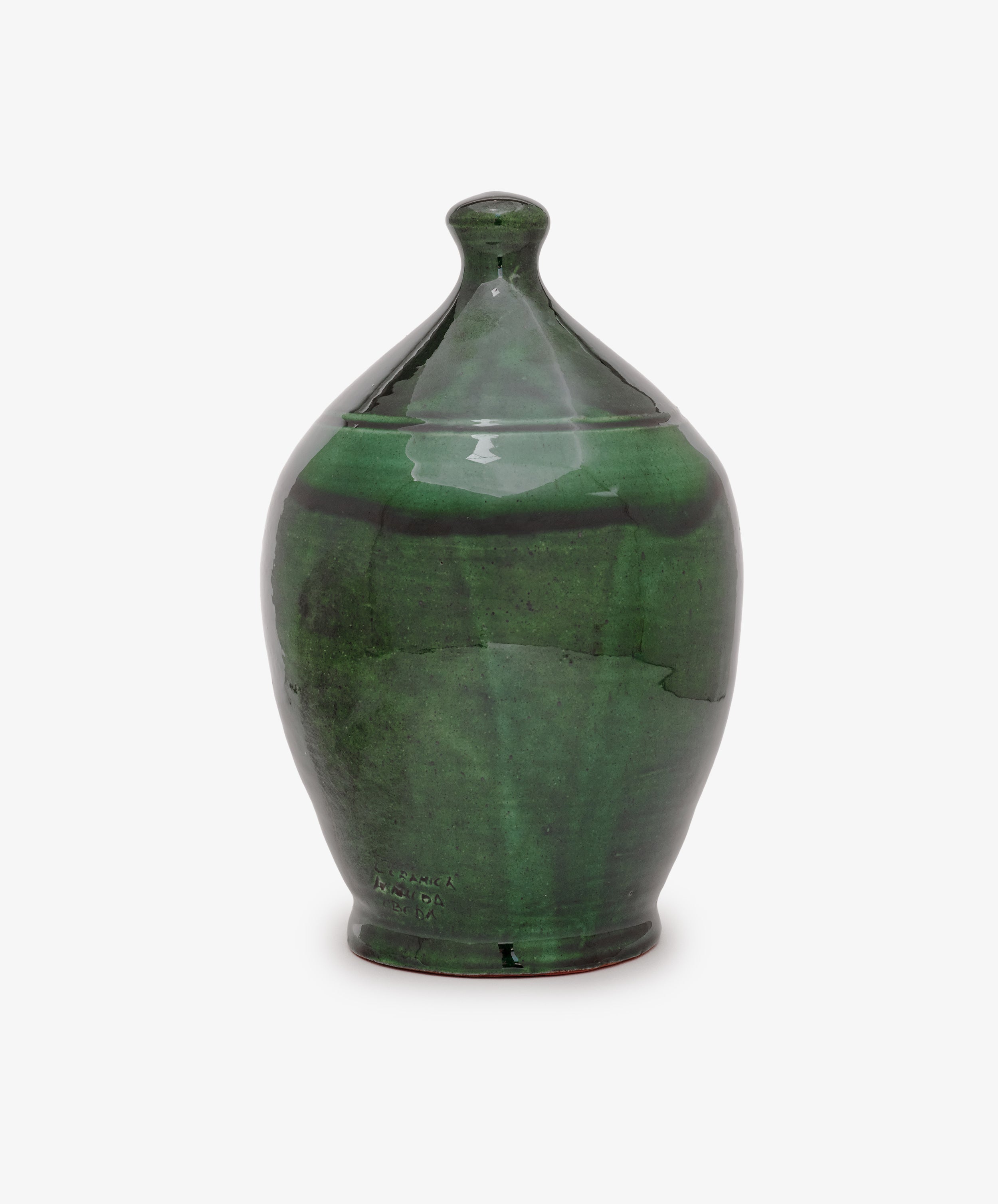 The Hugo Money Pot is a handcrafted green ceramic coin bank with a rounded body, slightly pointed top, glossy finish, and fitted lid—perfect for decorative use.