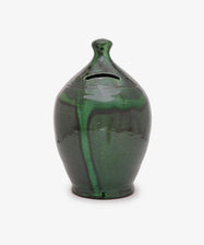 The Hugo Money Pot, a green ceramic money bank with a lid, glossy finish, and subtle marbled pattern, is displayed against a plain white background.