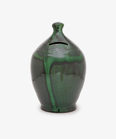 The Hugo Money Pot, a green ceramic money bank with a lid, glossy finish, and subtle marbled pattern, is displayed against a plain white background.