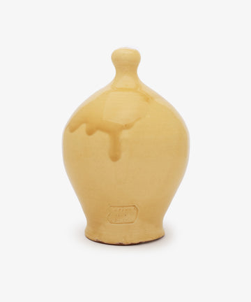 The Hugo Money Pot is a handcrafted ceramic money bank with yellow glaze, a rounded body, narrow base, and knobbed lid—ideal for saving coins. Displayed against a plain white background.
