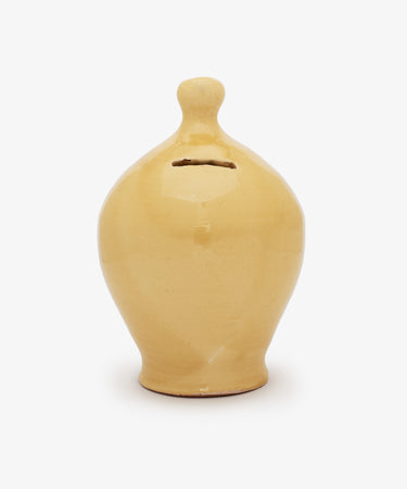 The Hugo Money Pot is a yellow handcrafted ceramic money bank with a rounded body, narrow neck, and front coin slot, shown against a plain white background.