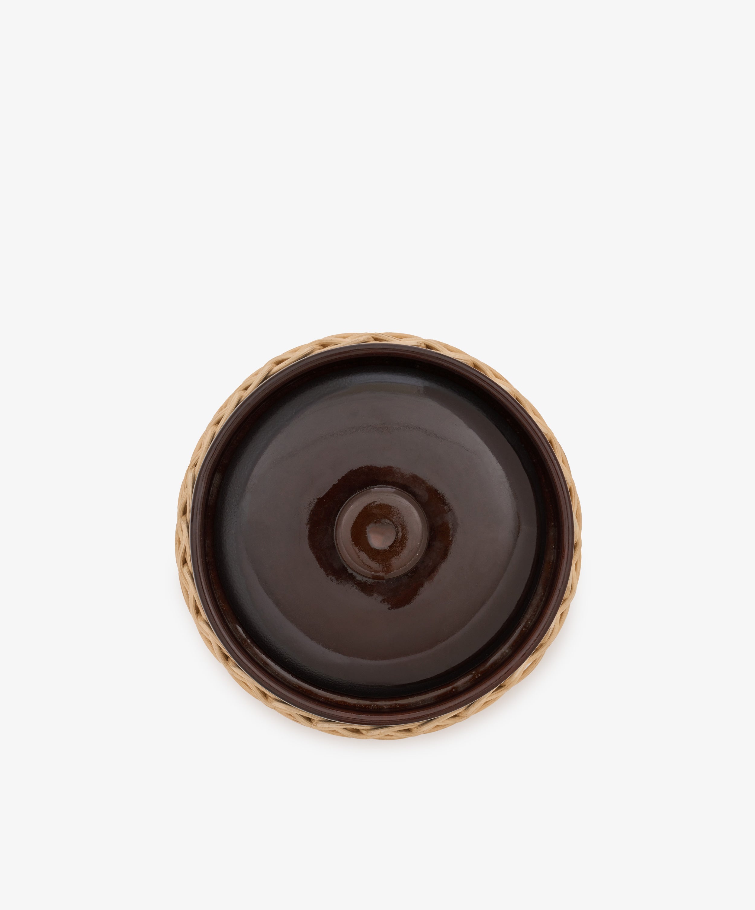 A round, dark brown Amany Casserole stoneware dish with a raised center, viewed from above and edged by a light brown woven border.