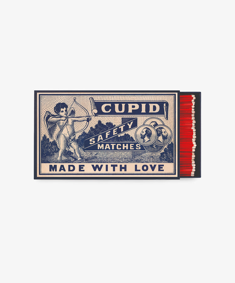 A giant matchbox labeled Luxury Matches features an illustration of Cupid with a bow and arrow—perfect as a charming dinner-party gift.