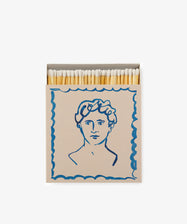 Luxury Matches: a keepsake-quality illustrated matchbox with white-tipped matches, featuring a classical head blue line drawing on the front.